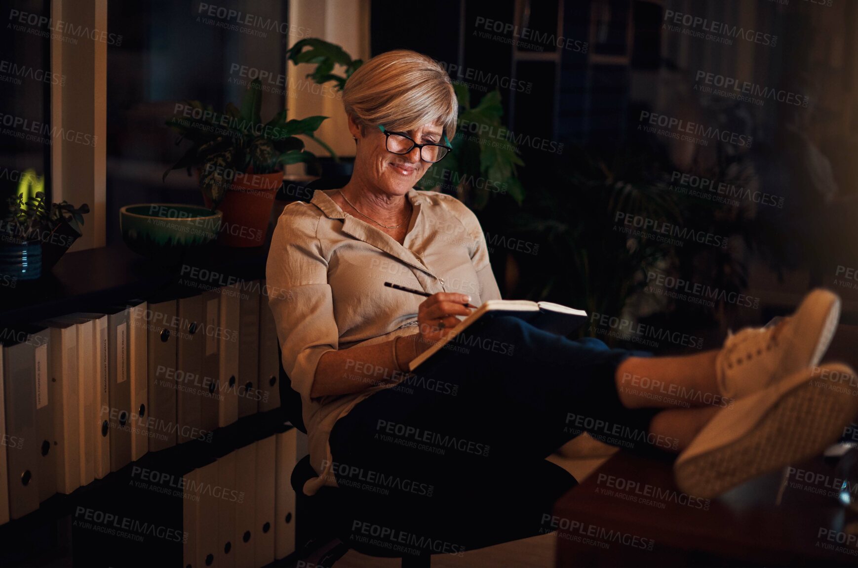 Buy stock photo Business woman, book and writing in office for agenda planning, brainstorming ideas and inspiration. Mature female writer, diary and notes for copywriting, working overtime and info summary at night