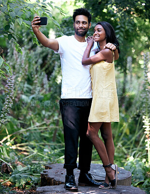 Buy stock photo Smile, hug in park and selfie, garden and of profile picture of Indian couple on social media. Nature, man and woman taking photo on smartphone, together and care for love, support or life partner