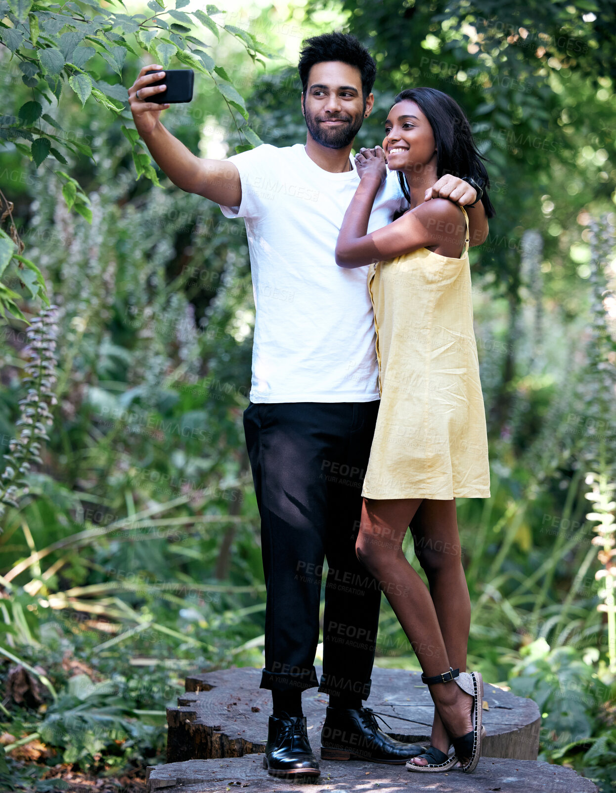 Buy stock photo Smile, hug in park and selfie, garden and of profile picture of Indian couple on social media. Nature, man and woman taking photo on smartphone, together and care for love, support or life partner