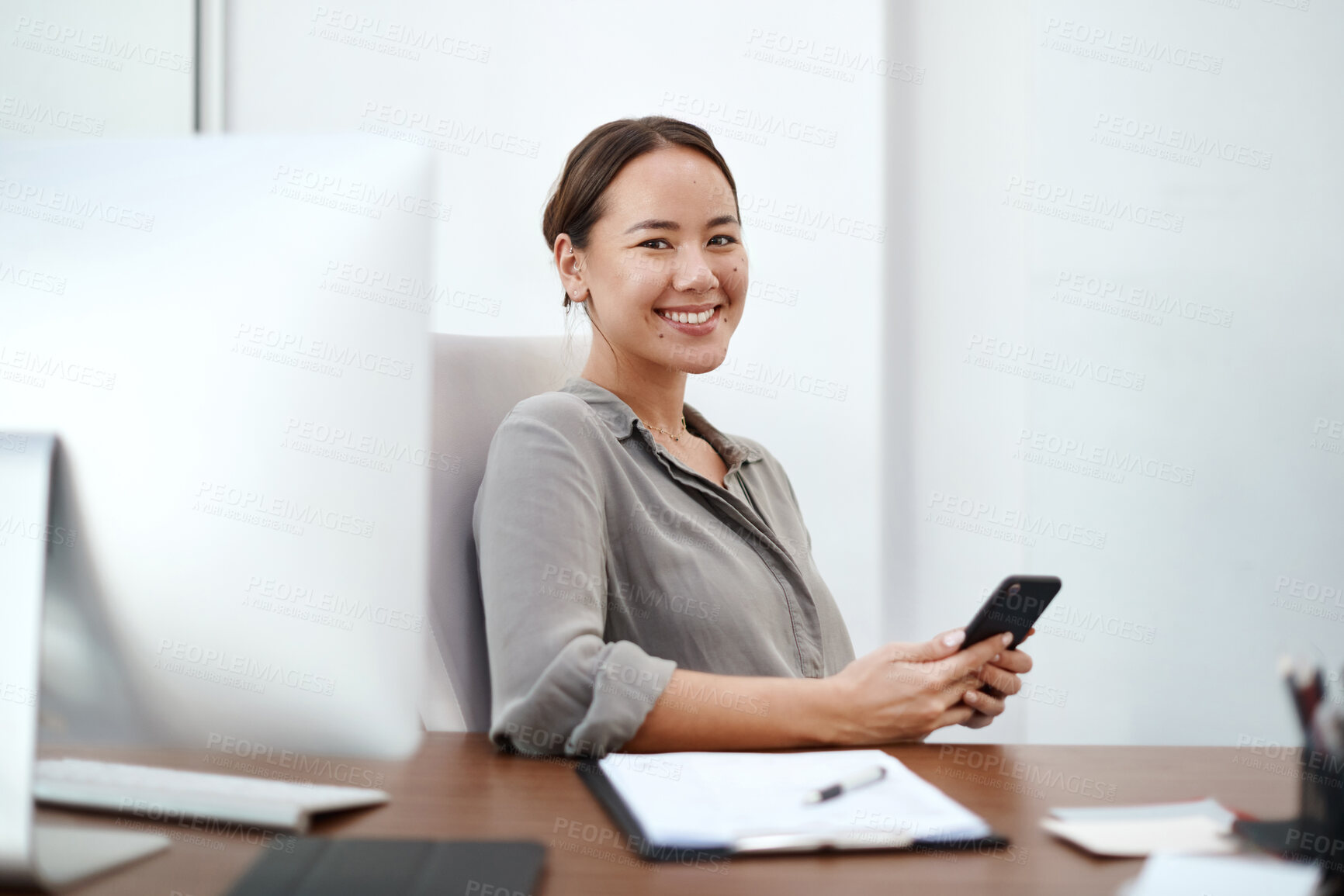 Buy stock photo Business, portrait and happy woman in office with phone, computer and notebook for planning secretary, schedule or email communication. Face, smile and girl receptionist with smartphone, app or notes