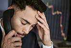 Stressed businessman on the phone, trading on the stock market during a financial crisis. Trader in a bear market with stocks crashing. Market crash and economy depression or failure