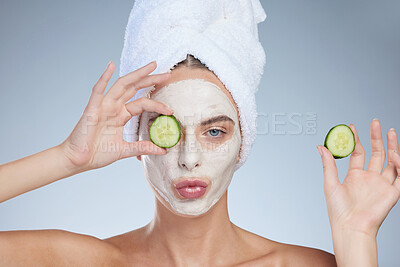 Buy stock photo Woman, cucumber eyes and face mask in studio, vegan beauty and skincare on blue background. Female person, natural cosmetics and organic clay treatment to pamper, sustainable dermatology and detox