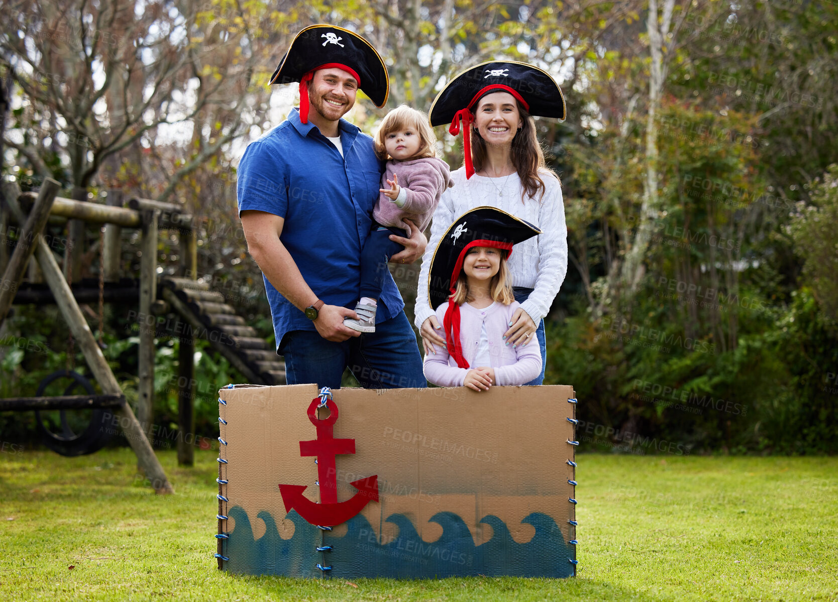 Buy stock photo Portrait, pirate and parents with children in park for playing, pretend games and creative fun. Family, happy and mom, dad and girls for bonding, relax and adventure in fantasy, boat and costume