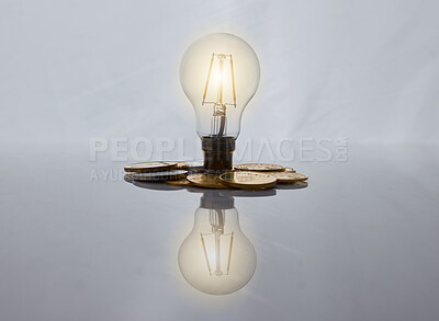 Buy stock photo Light bulb, finance and pile of coins in studio for banking investment with idea. Money, trading and lamp with cash funds for foreign exchange stocks for economy inflation by white background.