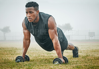 Buy stock photo Workout, push ups and man with dumbbells on grass for power training, endurance challenge or muscle growth. Field, athlete and black person on floor for performance, fitness or strength exercise