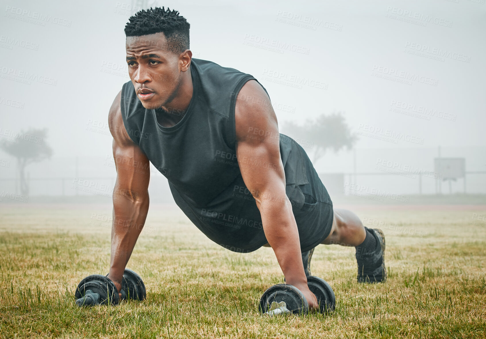 Buy stock photo Workout, push ups and man with dumbbells on grass for power training, endurance challenge or muscle growth. Field, athlete and black person on floor for performance, fitness or strength exercise