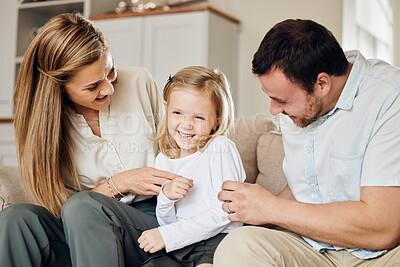 Buy stock photo Home, family and child with laughing at tickle for playful bonding, funny and love on weekend. Sofa, mother and father with daughter in living room for silly joke, humor and parenthood happiness