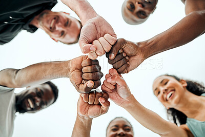 Buy stock photo Sky, fist bump and fitness people in outdoor for teamwork, support or running motivation. Low angle, diversity and group of friends with smile for synergy, community or race in morning in Spain