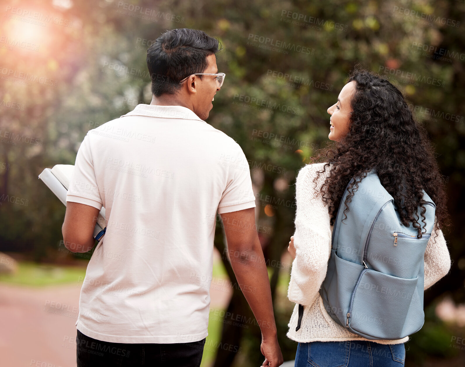 Buy stock photo University, students and walking to class on campus for conversation, education or knowledge. Back, young man and happy woman with backpack for learning, talking or scholarship with lens flare