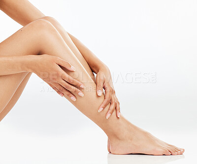 Buy stock photo Legs, hair removal and hands of person in studio for grooming, organic treatment or morning routine with white background. Beauty, body and model on floor for skincare, cosmetics or shine mockup