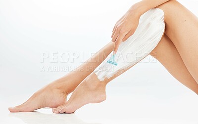 Buy stock photo Woman, legs and shaving with cream in studio, hair removal and razor or bladed tool for skincare on white background. Wellness, cosmetic product and body care or grooming, feminine routine and smooth