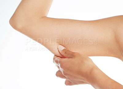 Buy stock photo Woman, hands and pinch arm in studio for health, weight loss and muscle development for wellness. Person, body and skin on white background for fitness goal, beauty and cosmetic surgery results