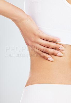 Buy stock photo Closeup, hand and woman with back pain in studio for stress, muscle problem and arthritis risk. Body underwear, model and spine massage for fibromyalgia, injury and scoliosis by white background