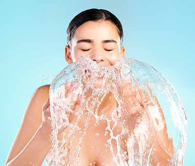 Buy stock photo Happy, woman and water or liquid in studio for skincare, dermatology and glow or wellness. Hygiene, model girl and smile of hands with splash for facial and aesthetic or shine by blue background 