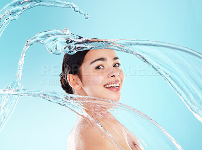 Buy stock photo Skincare, girl and water splash in studio for portrait, hydration or healthy skin. Body wash, dermatology or happy woman on blue background for cleansing, spa treatment or luxury wellness with aqua