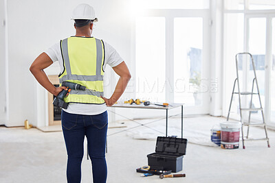 Buy stock photo Construction site, drill and back of handyman with tools, helmet and thinking for project. Male contractor, equipment and safety wear in building for maintenance, repairs and idea in profession