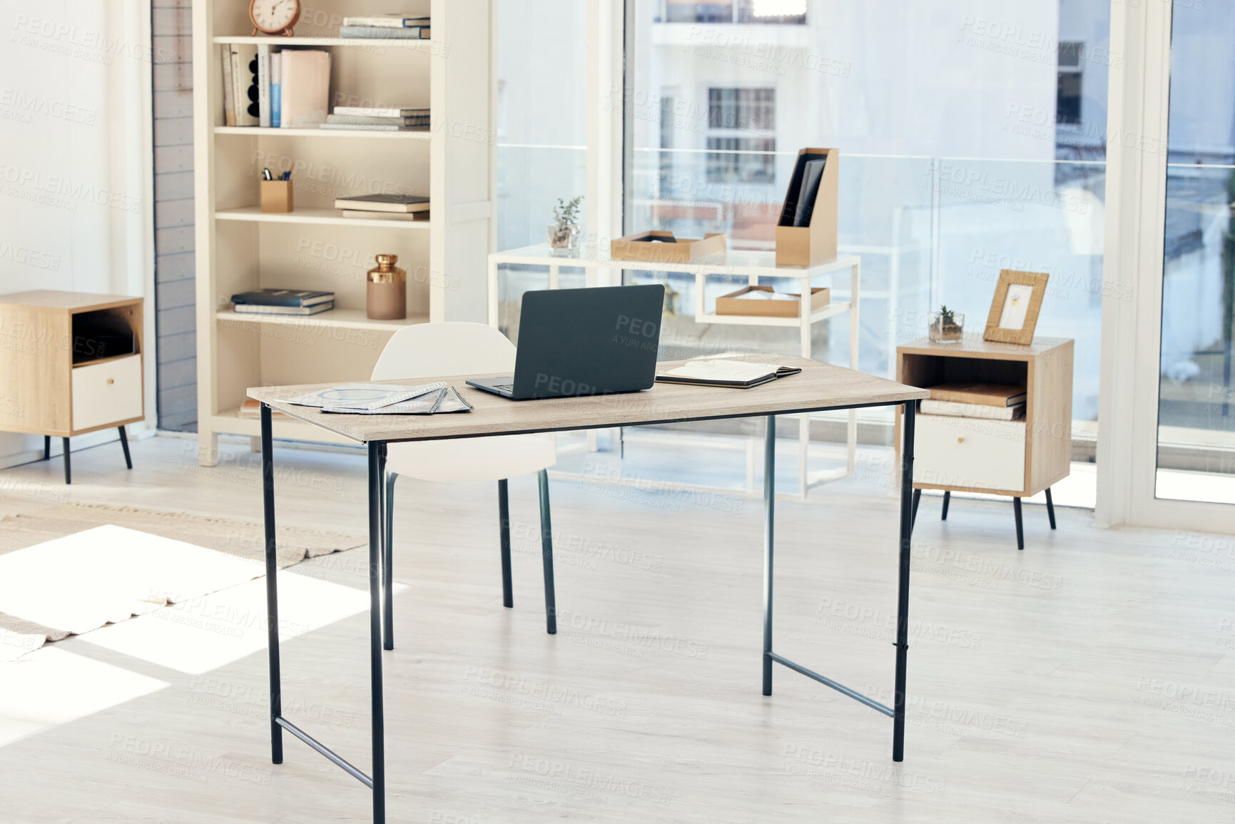 Buy stock photo Shot of an empty office with a laptop on the table