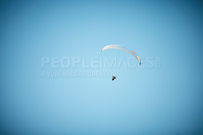 Buy stock photo Space, parachute or person paragliding in blue sky for holiday, flight freedom or courage with extreme sport. Mockup, fearless paraglider in outdoor adventure for health, vacation or travel in air