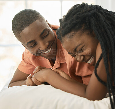 Buy stock photo Black couple, happy and laugh on bed with love relationship, bonding and comedy conversation in home. African woman, man and joke on mattress for silly story, care and vacation together in Kenya