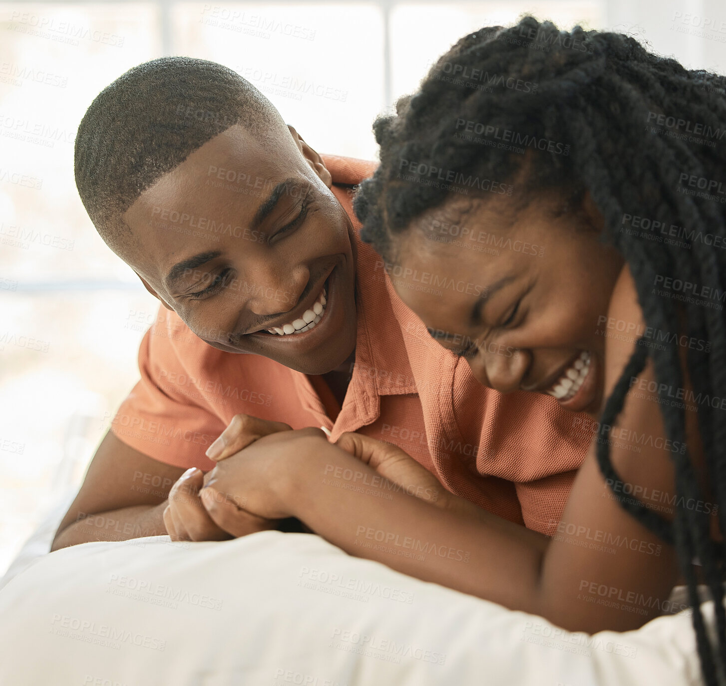 Buy stock photo Black couple, happy and laugh on bed with love relationship, bonding and comedy conversation in home. African woman, man and joke on mattress for silly story, care and vacation together in Kenya