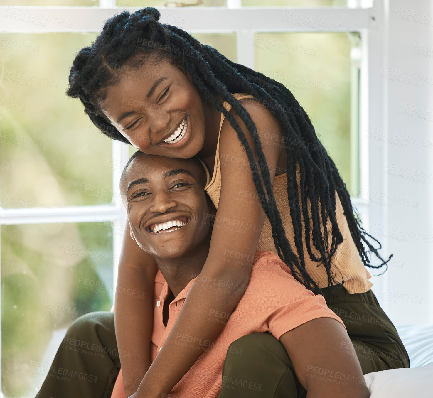 Buy stock photo Laugh, hug and black couple in home for love, care or support with funny partner. Face, African man and woman piggyback for trust, connection and bonding together for happiness in bedroom to relax