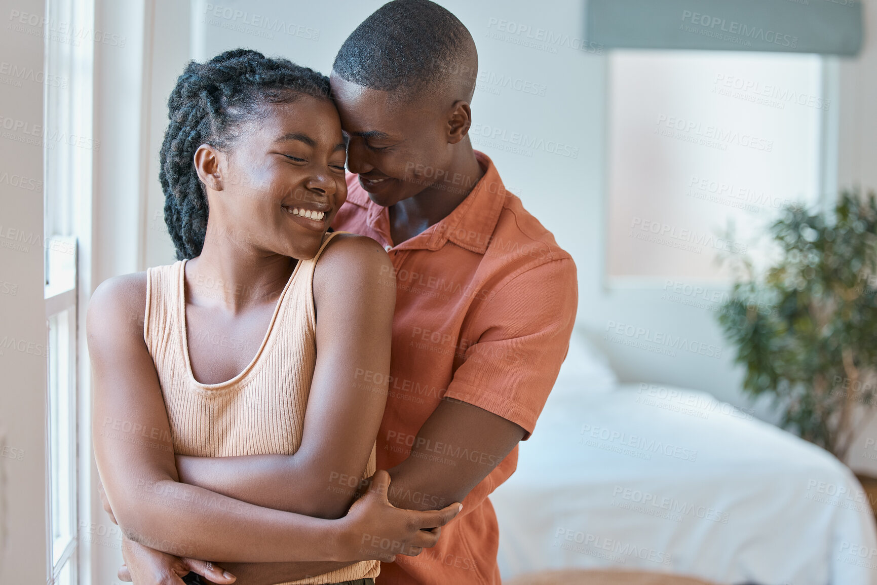 Buy stock photo Love, happy or black couple hug in bedroom to relax, smile or enjoy anniversary together for peace or trust. People, romantic woman and man bonding in apartment for care, support or special moment