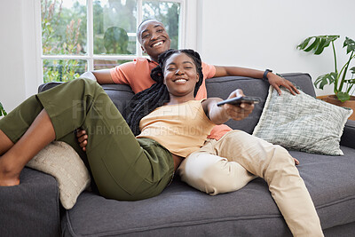 Buy stock photo Black couple, happy together and watching tv on sofa for bonding, streaming movie and weekend peace. African woman, man and television broadcast for series, change channel and subscription in home