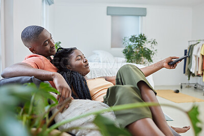 Buy stock photo Black couple, happy together and watching tv on couch for bonding, streaming movie and weekend in home. African woman, man and television broadcast for series, change channel and cable subscription