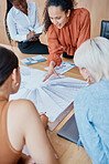 Close up of a young mixed race woman giving a presentation to a group of female only colleagues at a boardroom meeting in a office. A team of diverse business women planning , brainstorming and strategizing 