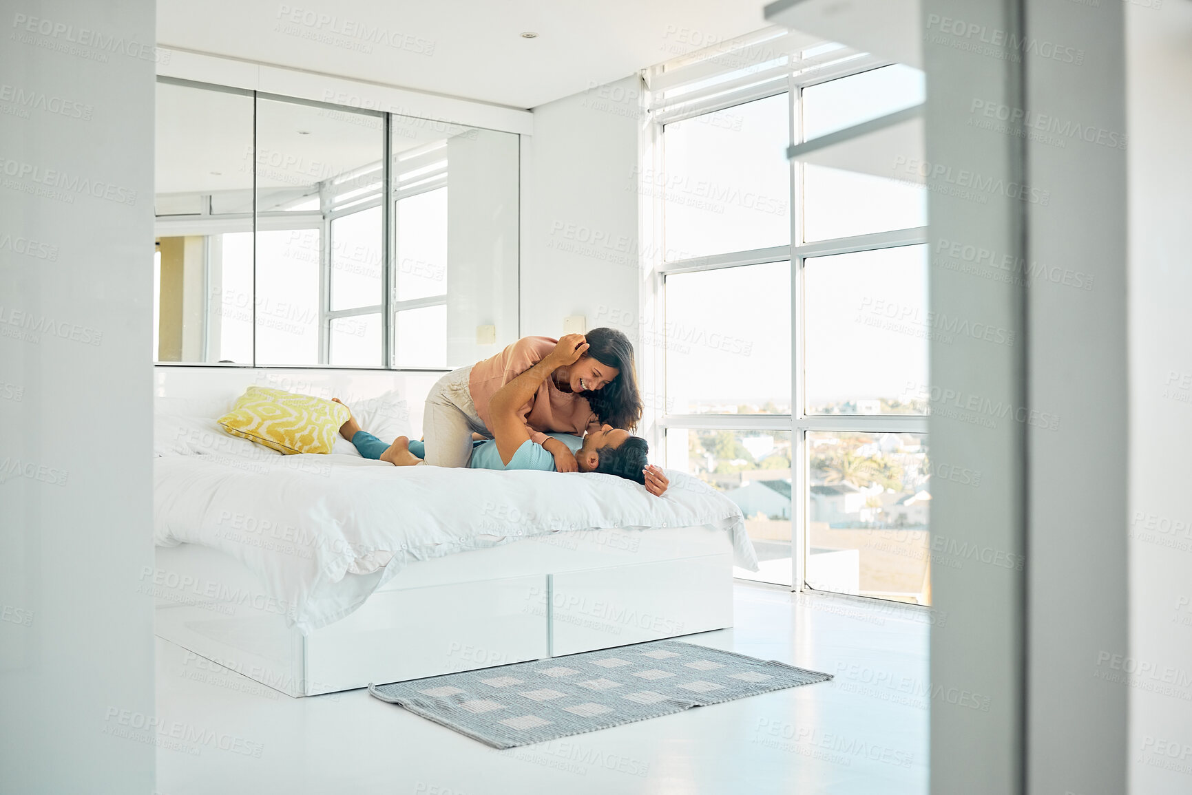 Buy stock photo Couple, happy and bed in hotel for love, romance and vacation for anniversary. Man, woman and bonding in guest house bedroom for trust, commitment and passion on holiday for milestone celebration