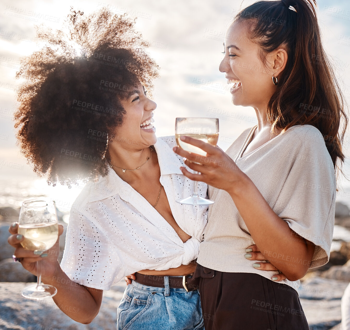 Buy stock photo Girl, friends and drinking wine on beach with laughing, bonding and hugging on holiday or vacation in Miami. People, women and happy with alcohol glass with funny story at ocean and summer break