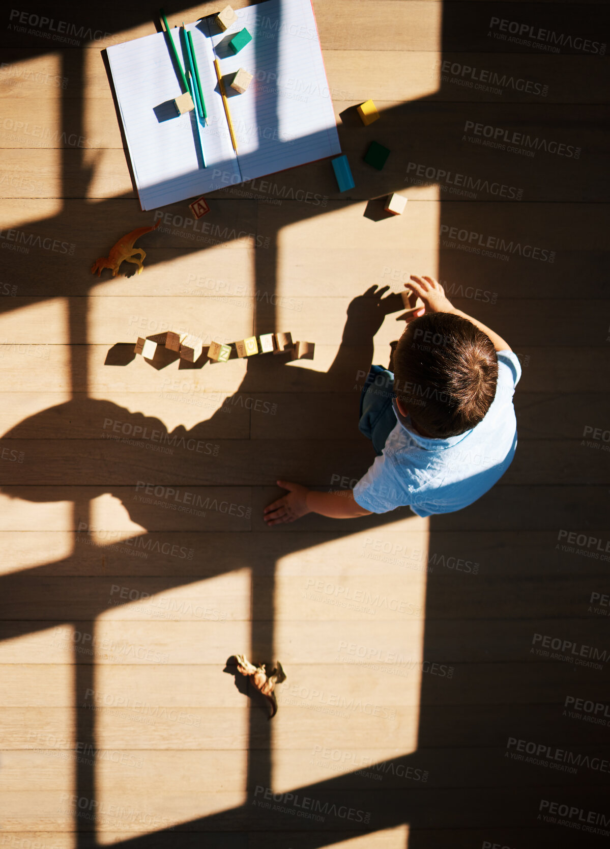 Buy stock photo Top view, child and blocks for learning in home, education and toys for playing in living room. Above, boy and toddler for creative activity to develop skills, games and cubes or books on floor