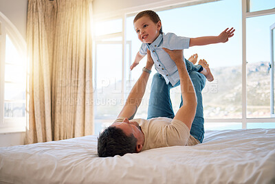 Buy stock photo Father, boy and lifting game in home, playing and support for airplane adventure in bedroom. Daddy, son and toddler for energy or happiness on bed, love and kid learning to fly or balance for freedom