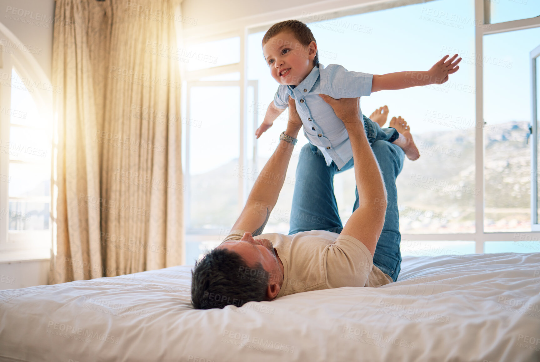 Buy stock photo Father, boy and lifting game in home, playing and support for airplane adventure in bedroom. Daddy, son and toddler for energy or happiness on bed, love and kid learning to fly or balance for freedom