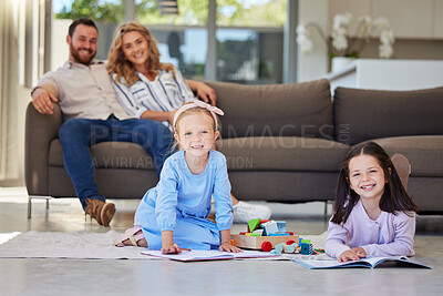 Buy stock photo Children, play and floor with toys and parents on couch, smile and portrait in home living room. Relax, drawing and girls for playdate with friend in lounge, mother and dad person on sofa for rest