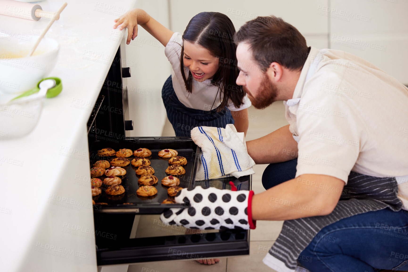 Buy stock photo Oven, girl and father with cookies for baking, preparation and checking on tray in home kitchen. Family, dad baker and happy kid for skills development, learning and observation of biscuits by stove