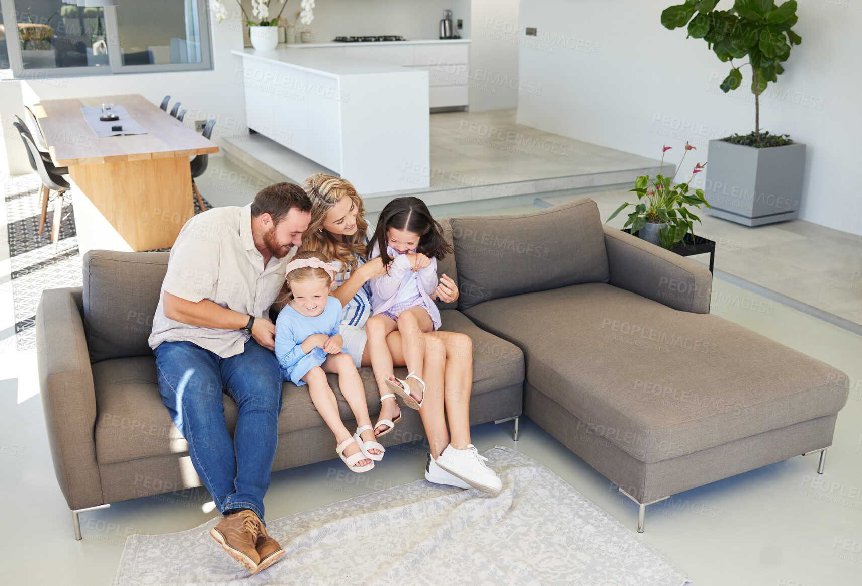 Buy stock photo Lounge, playing and tickling of children, parents and fun with kids in house, bonding and games in weekend.  Relax, man and woman with girls, love and care of family in apartment, sofa or living room