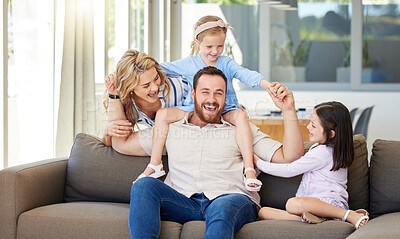 Buy stock photo Happy family, portrait and playing with children on sofa for bonding, holiday or weekend together at home. Father, mother and little girls, sisters or siblings enjoying time with parents at house