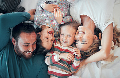 Buy stock photo Above, portrait and happy family on bed for love, support and relax together in home. Mom, dad and parents with kids or excited at house, care and protection or morning for children in apartment