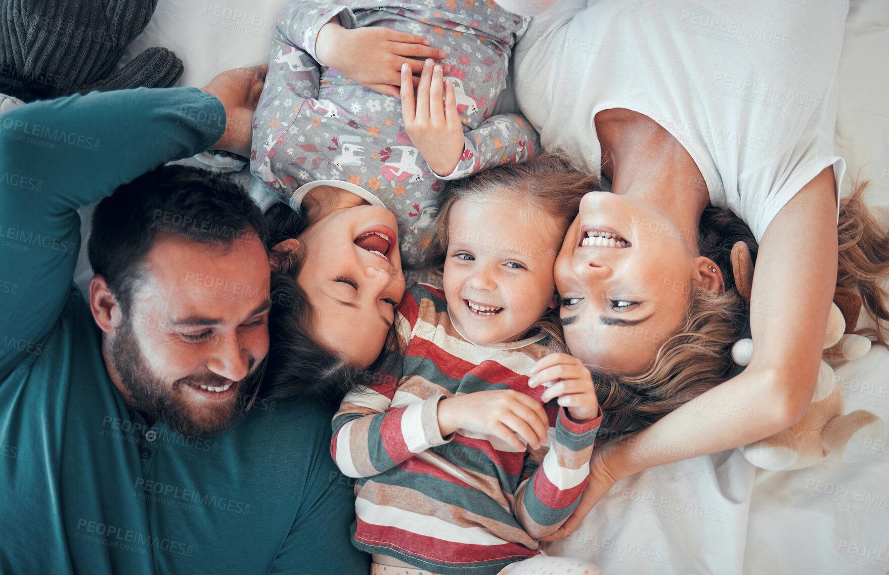 Buy stock photo Above, portrait and happy family on bed for love, support and relax together in home. Mom, dad and parents with kids or excited at house, care and protection or morning for children in apartment