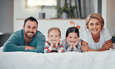 Buy stock photo Mother, father and children on bed in portrait for happiness, bonding and relax together with on weekend. Family, face and support in home with smile for wellness, relationship and care in morning