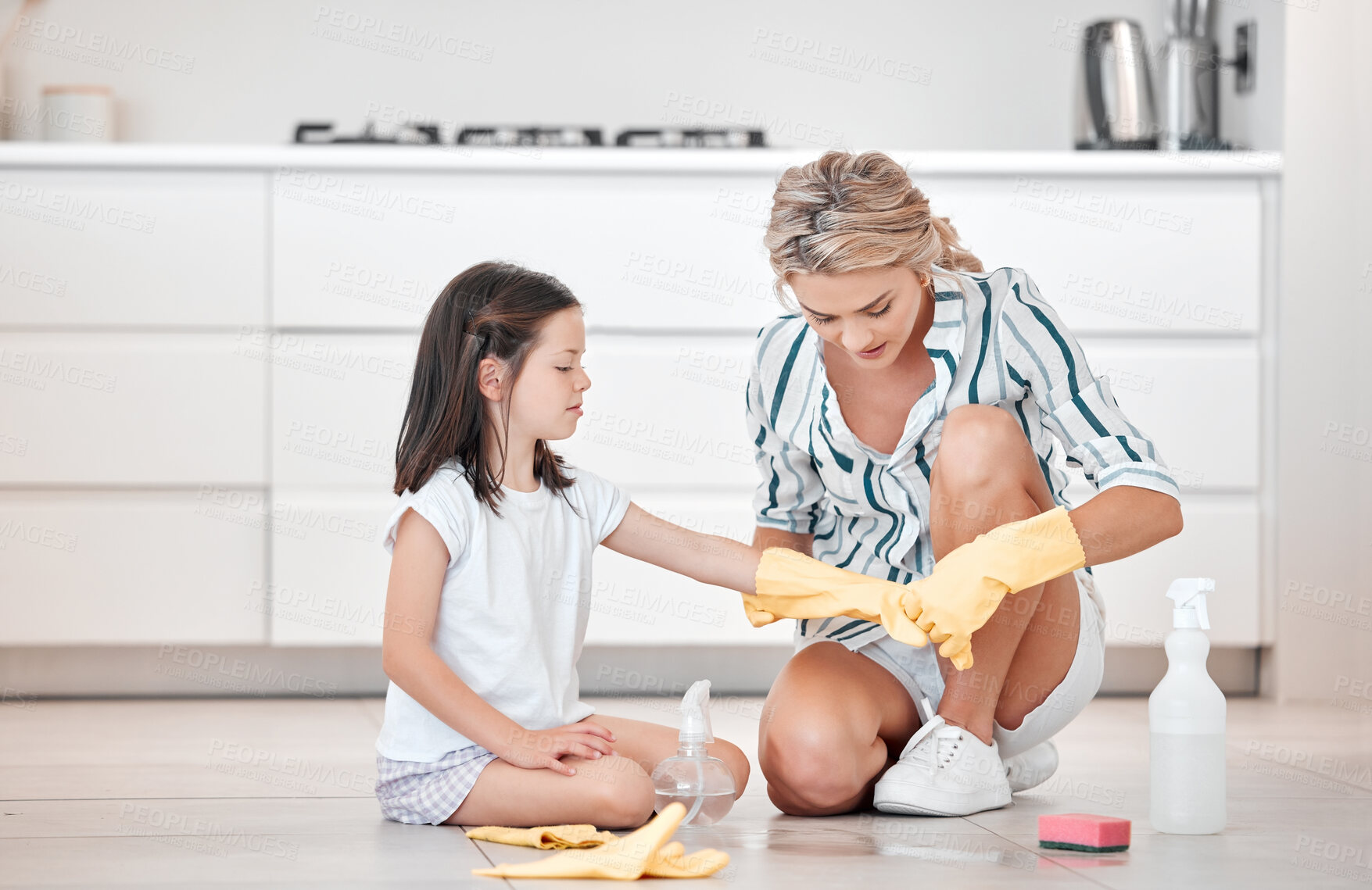 Buy stock photo Kitchen, mother and child with gloves for cleaning, supplies and protection for chemical on floor. Housework, mama and little girl with product, helping and kid care for single parent in apartment