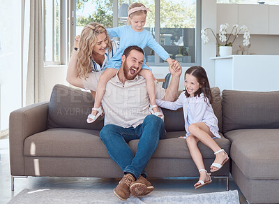 Buy stock photo Parents, children and play on sofa with laugh, excited or piggyback with bonding in family house. Father, mother and daughter siblings with care, love or happy for connection on couch in living room