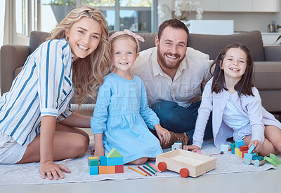 Buy stock photo Parents, kids and toys in portrait on floor with smile, play and learning with blocks for problem solving. Father, mother and daughter children on carpet with bonding, care and love in family house