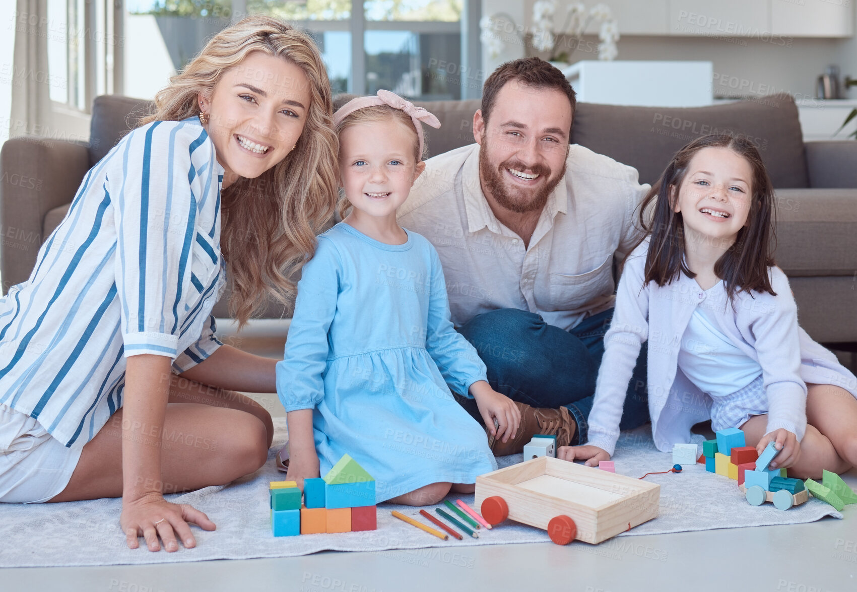 Buy stock photo Parents, kids and toys in portrait on floor with smile, play and learning with blocks for problem solving. Father, mother and daughter children on carpet with bonding, care and love in family house