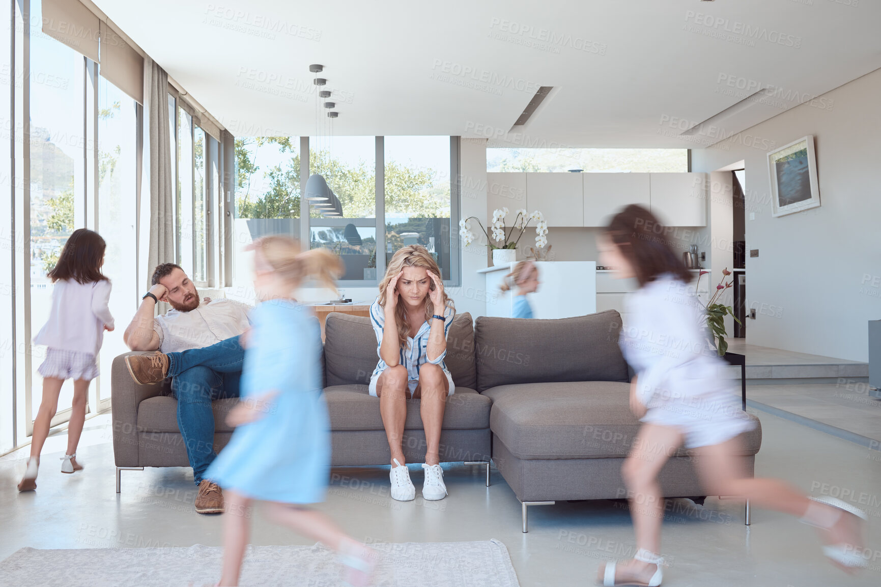 Buy stock photo Parents, children and running in home with chaos, stress and overwhelmed environment with headache of burnout. Mother, father and girl kids in house with energy or hyper from adhd and autism behavior