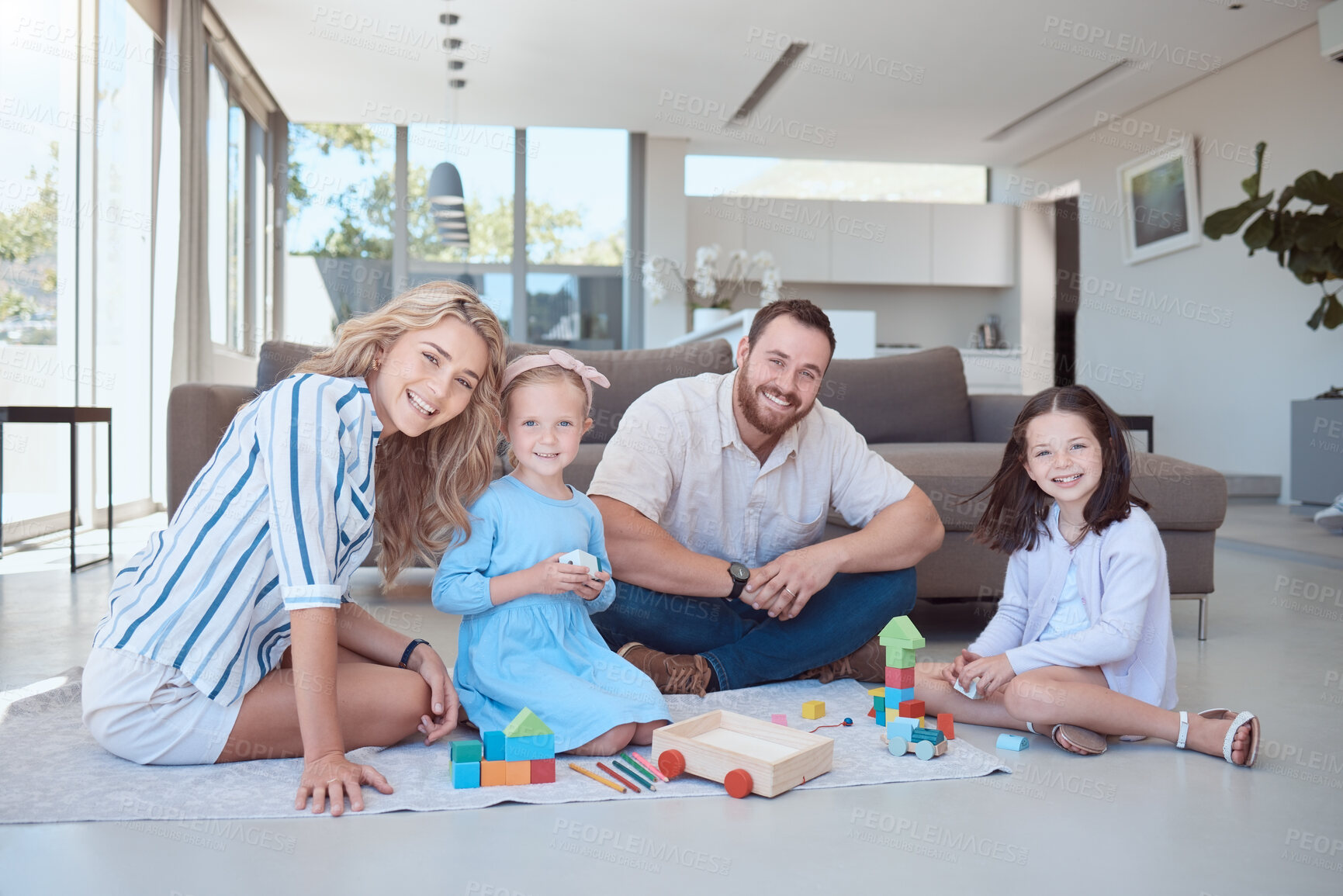 Buy stock photo Parents, children and toys in portrait on floor with smile, play and learning with blocks for problem solving. Father, mother and daughter kids on carpet with bonding, care and love in family house