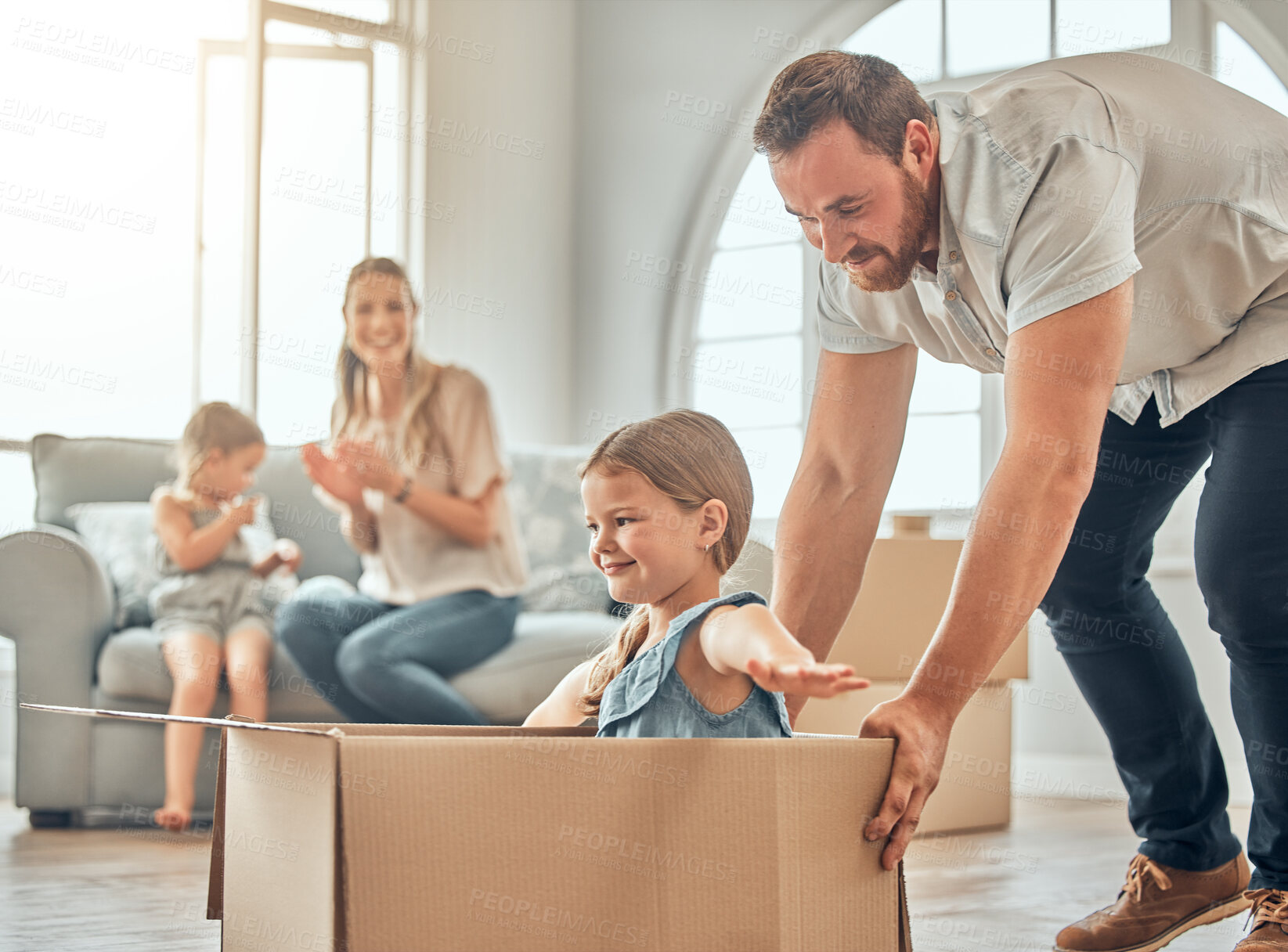 Buy stock photo Family, man and girl with box in new home for relocation, playing or real estate. Children, parents and dad with daughter for property investment, happiness or bonding together in living room