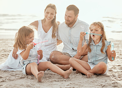 Buy stock photo Love, parents and children at a beach for bubbles, fun and adventure in nature while bonding. Soap, wand and happy family at ocean for travel, journey and support, trust and learning at sea together