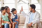 Young doctor celebrating good news with his patient. Smiling girl high fives her doctor after learning of positive test results